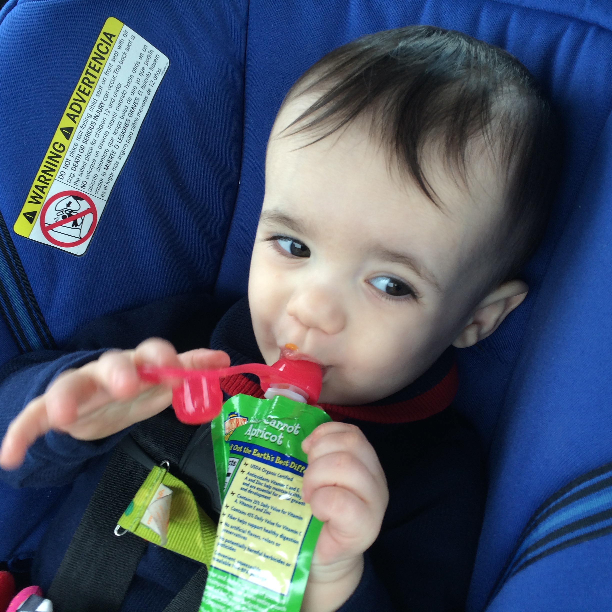 boy drinking from pouch with choomee sip'n in car seat